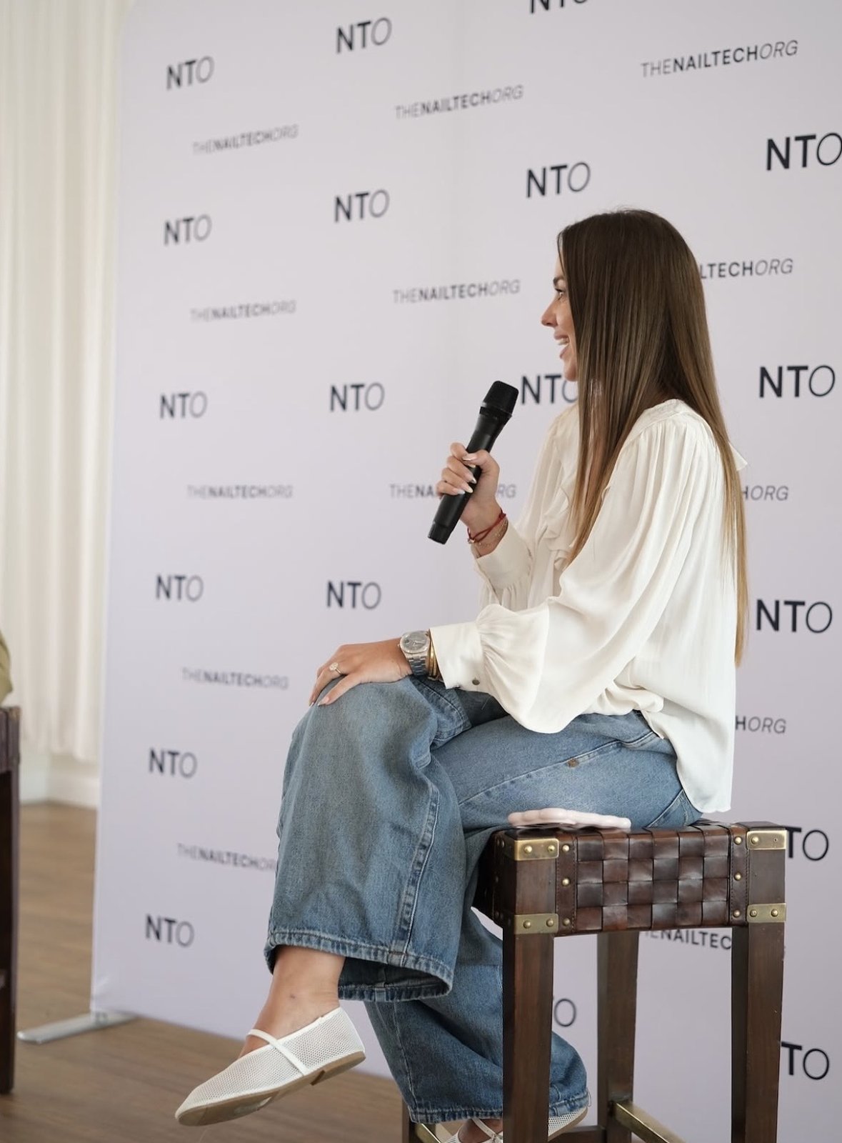 Amy Guy speaking on a panel at a The Nail Tech Org event