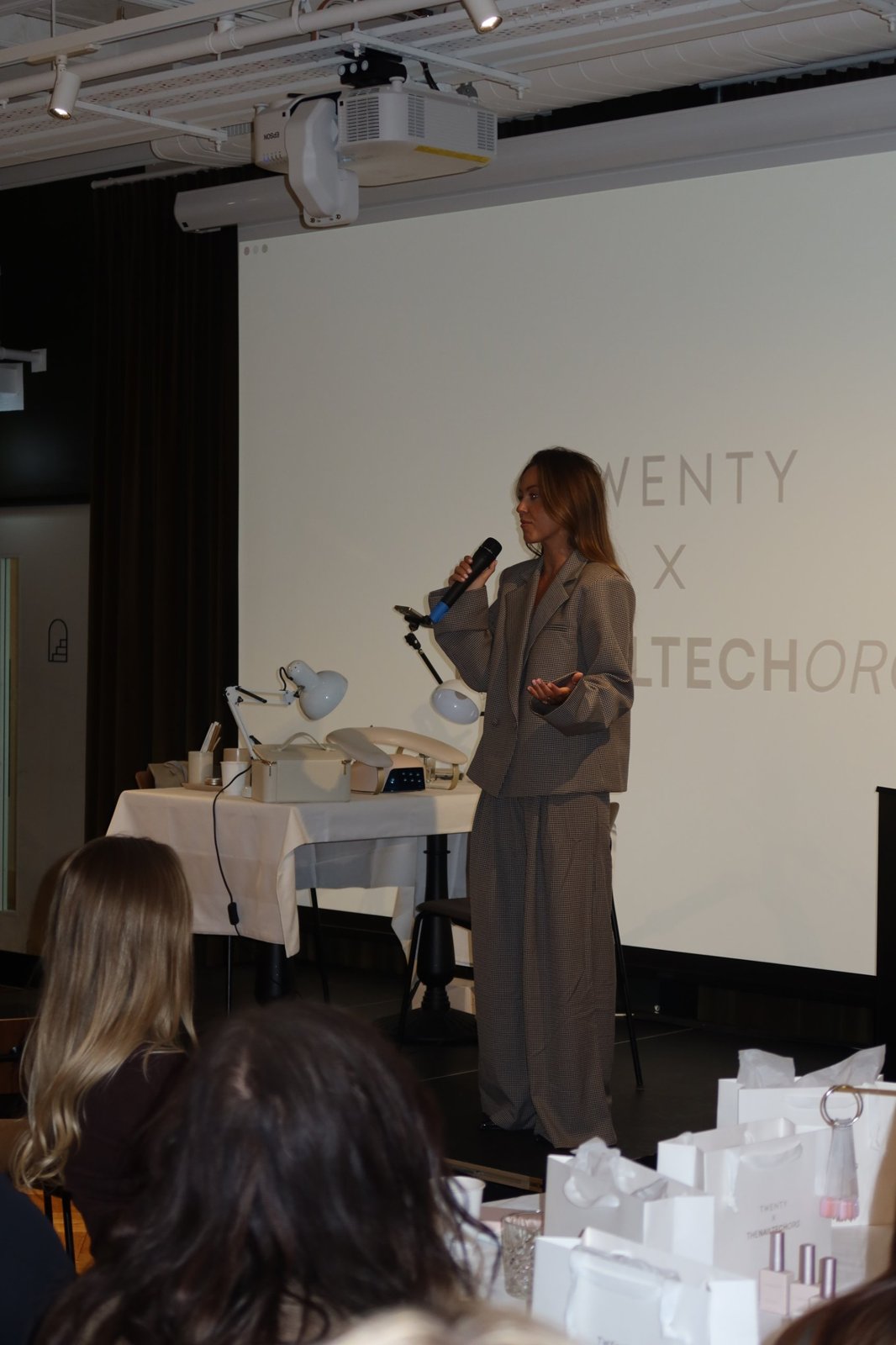 Amy Guy speaking to an audience at a TWENTY x The Nail Tech Org event